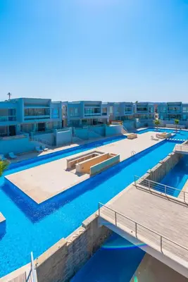 an overhead view of a large swimming pool with blue water at 1BR with private Heated Jacuzzi at Sholan Elgouna in Hurghada
