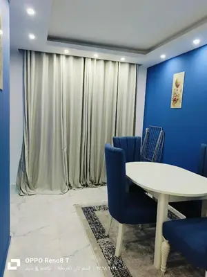 a meeting room with a white table and blue chairs at Fanadir Bay Resort in Hurghada, Egypt in Hurghada