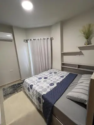 a small bedroom with a bed with a shower at Charming 1-Bed Chalet in Hurghada in Hurghada