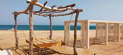 a swing set on a beach with the ocean at Charming 1-Bed Chalet in Hurghada in Hurghada