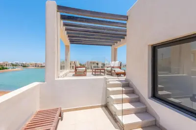 a balcony with a view of the water at Comfy 3BR Standalone in Tawila, El Gouna. Lagoon & Pool access in Hurghada