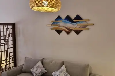 a living room with a couch and a painting on the wall at Tolles Modernes Studio in Aldau in Hurghada
