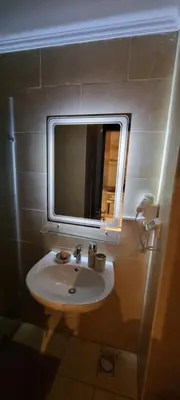 a bathroom with a sink and a mirror at Tolles Modernes Studio in Aldau in Hurghada