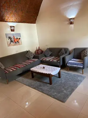 a living room with two couches and a coffee table at The House Of Love in Luxor
