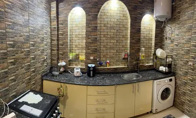 a bathroom with a sink and a washing machine at The House Of Love in Luxor