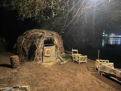 a small hut with a sign on it at night at Salatoos Mango Garden and Guesthouse in Aswan
