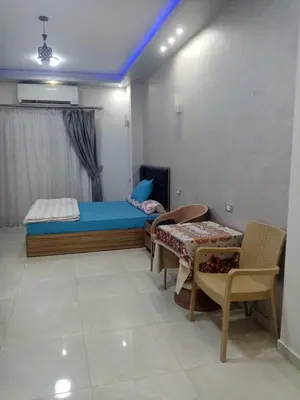 a bedroom with a bed and a table and chairs at Makramia studio in Hurghada