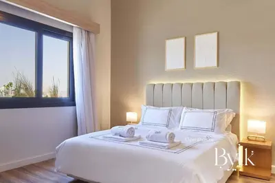 a bedroom with a large white bed with a window at BYTK - Casa Del Mar in Hurghada