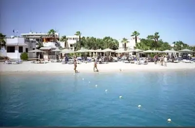 a group of people on a beach with umbrellas at Makramia A107 studio in Hurghada