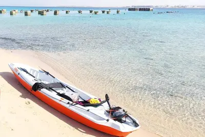 a red and white boat sitting on the beach at 1 Bed Apartment with Public Pool HotTub & PetsOk in Hurghada