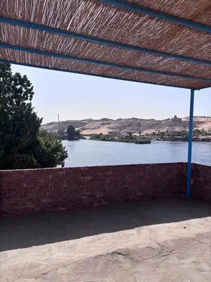 a view of a river from under a roof at Ajwa Guest House in Aswan