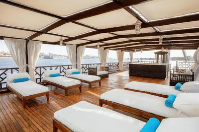 a room with couches and chairs on a boat at Farouz El Nil I Nile Cruise - Every Monday from Luxor for 07 & 05 Nights in Ţawd