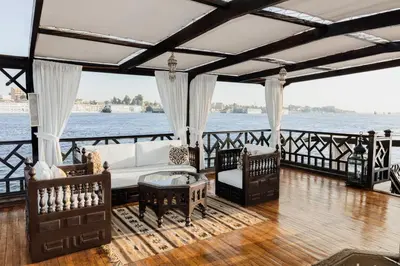 a living room with a couch and chairs on a boat at Farouz El Nil II Nile Cruise - Every Monday from Luxor for 07 & 05 Nights in Luxor