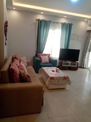 a living room with a couch and a table at A216 flat Al Makramia in Hurghada