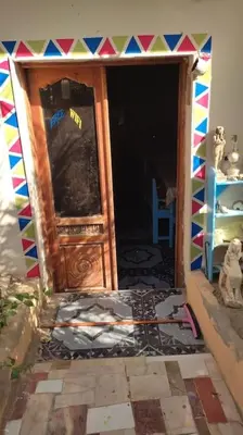 an entrance to a room with a wooden door at Tibs mountain view in Al Aqālitah