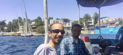 two men on a boat in the water at Reko Houses in Elephantine Island in Aswan