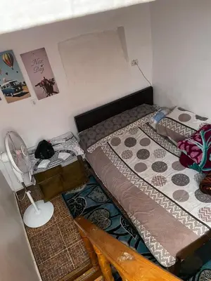 a room with two beds and a lamp in it at Reko Houses in Elephantine Island in Aswan