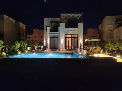 a villa with a swimming pool at night at Luxury 4 bedroom villa - Cyan ElGouna in Hurghada