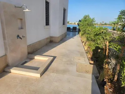 a walkway outside of a building with a view of the water at Luxury 4 bedroom villa - Cyan ElGouna in Hurghada