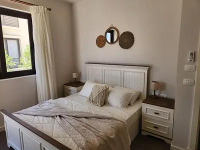 a bedroom with a bed and a mirror and a window at Luxury 4 bedroom villa - Cyan ElGouna in Hurghada