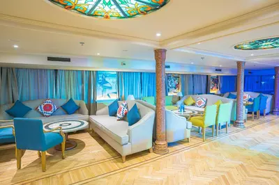a living room with couches and chairs and a stained glass ceiling at 4-Day 3-Night Guided Nile Cruise from Aswan to Luxor every Monday, Wednesday & Friday Departures in Aswan