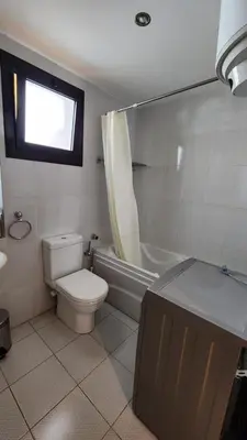 a bathroom with a toilet and a tub and a sink at apartment 2 bedrooms in the view in Hurghada