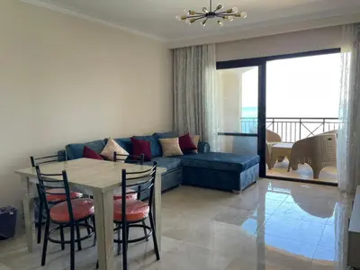 a living room with a couch and a table and chairs at شقه بغرفه نوم في الغردقه in Hurghada