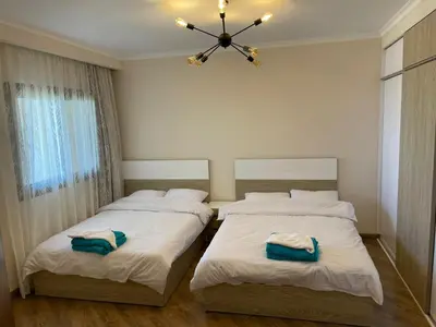 a bedroom with two beds and a ceiling fan at شقه بغرفه نوم في الغردقه in Hurghada