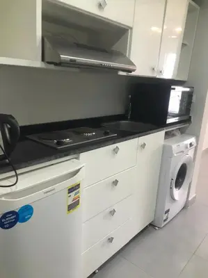a kitchen with a stove and a washing machine at Scandic resort سكانديك ريزورت in Hurghada