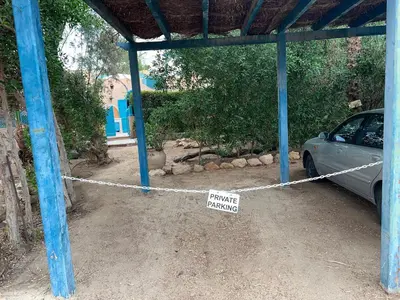 a car parked in a garage with a hanging sign at Casa Della Laguna in Gouna in Hurghada