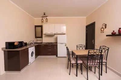a kitchen and dining room with a table and chairs at 2bedrooms apartment 53 in Hurghada