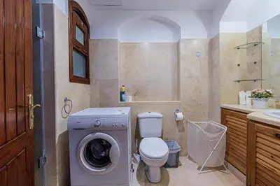 a bathroom with a washing machine and a toilet at Style Apartment in nubian design at lagoon in Hurghada