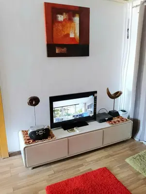 a living room with a flat screen tv on a table at Шале Stella di mare Makadi Хургада in Hurghada