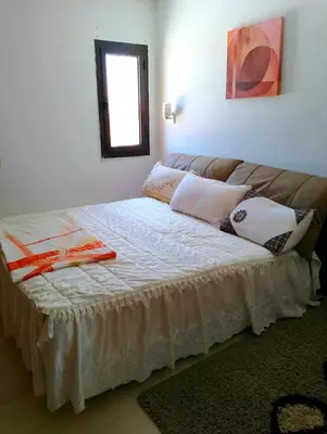 a large bed in a room with a couch at Шале Stella di mare Makadi Хургада in Hurghada
