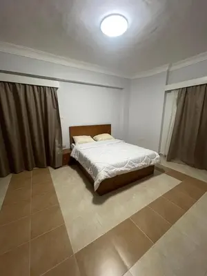 a bedroom with a bed in the corner of a room at Hurghada-Magawish Villa 4 in Hurghada