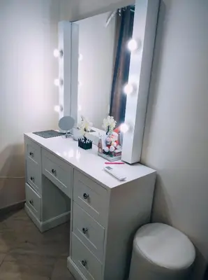 a bathroom with a sink with a mirror and a toilet at Oriental Tail Home in Hurghada