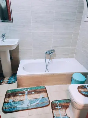 a bathroom with a tub and a toilet and a sink at Oriental Tail Home in Hurghada