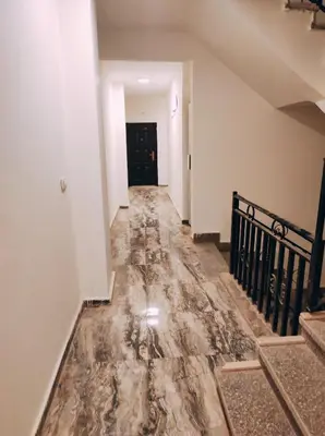 an empty hallway with a marble floor in a house at Oriental Tail Home in Hurghada