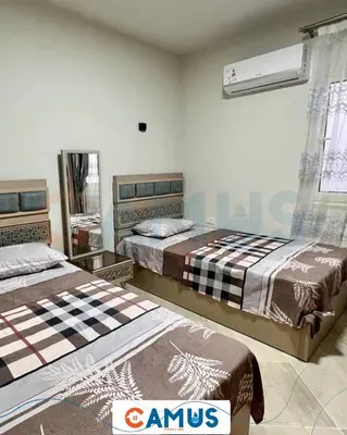 a bedroom with two beds and a window at CAMUS 343, Princess Resort in Hurghada