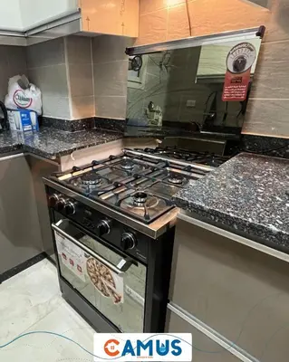 a kitchen with a stove top oven in a kitchen at CAMUS 343, Princess Resort in Hurghada