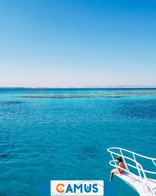 a child sitting on the back of a boat in the water at CAMUS 343, Princess Resort in Hurghada