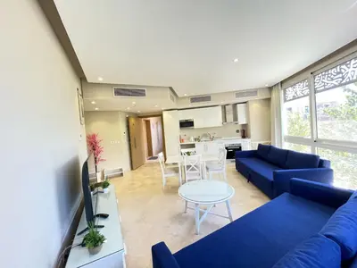 a living room with a blue couch and a table at El Gouna Mangroovy 1-Bedroom Sleeps 4-Persons, M8-4C-14 in El Gouna