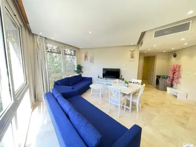 a living room with a blue couch and a table at El Gouna Mangroovy 1-Bedroom Sleeps 4-Persons, M8-4C-14 in El Gouna