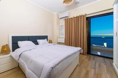 a bedroom with a large bed and a large window at Felfela View in Hurghada
