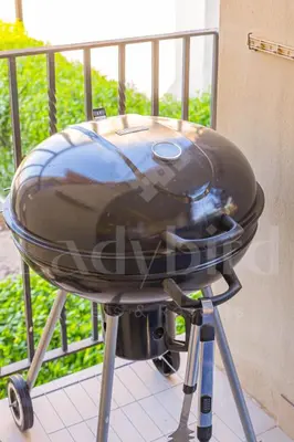 a bbq grill sitting on top of a balcony at Ladybird - Veranda Beach House in Hurghada