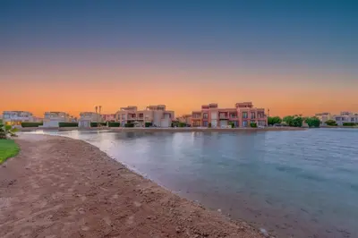a group of houses on the shore of a body of water at Elegant 4BR in Tawila, Gouna. Private Pool, Lagoon in Hurghada