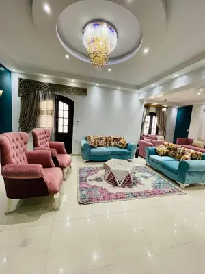 a large living room with couches and a chandelier at El Hady Apartments with Swimming Pool in Luxor