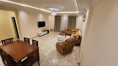 a living room with a couch and a table at Wa set Luxor Apartment in Luxor