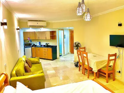 a living room with a couch and a table at Top floor premier view chalet in Red sea Hurghada in Hurghada