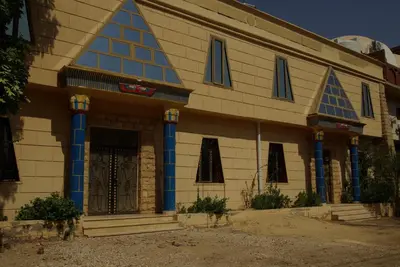 a building with blue columns and a door at Pyramids Luxor Hotel & SPA in Luxor